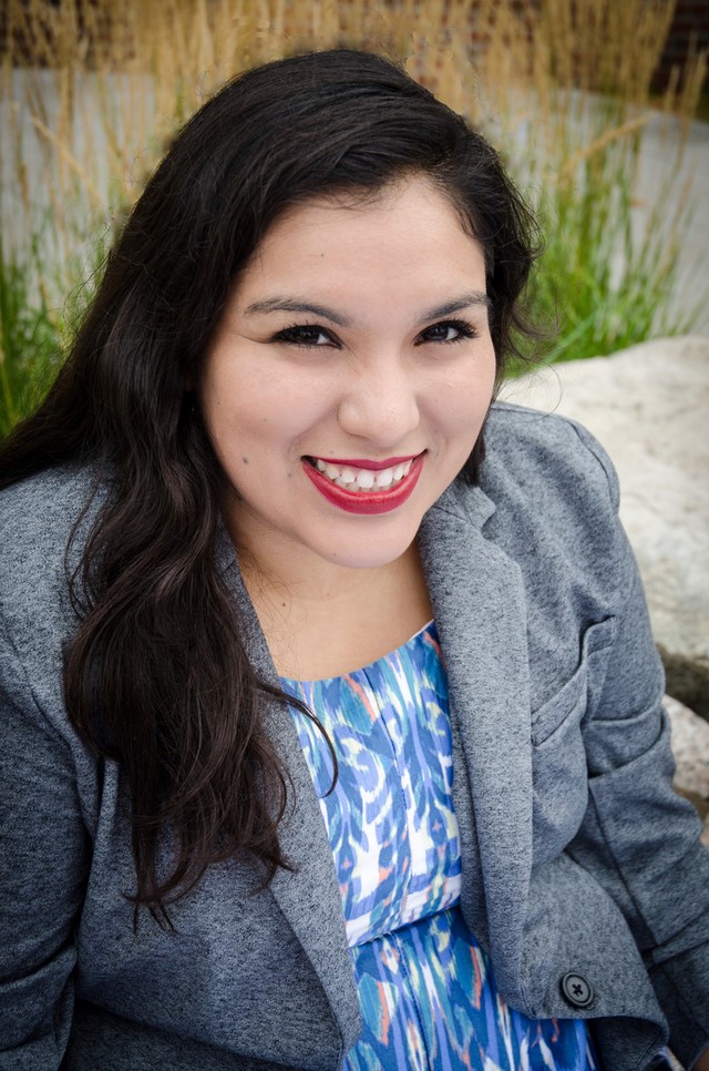 headshot of Jaquelin. She is weating a blue dress and smiling at the camera.